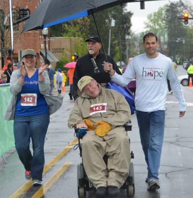 Brevard Residents John & Heather Crawford Cross the Finish Line with Executive Director Deric Milligan