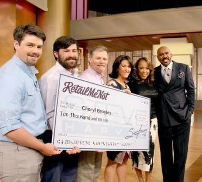 The Broyles Family receives their gift from Steve Harvey.