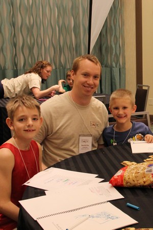 David helping children at a Legacy Retreat in 2015