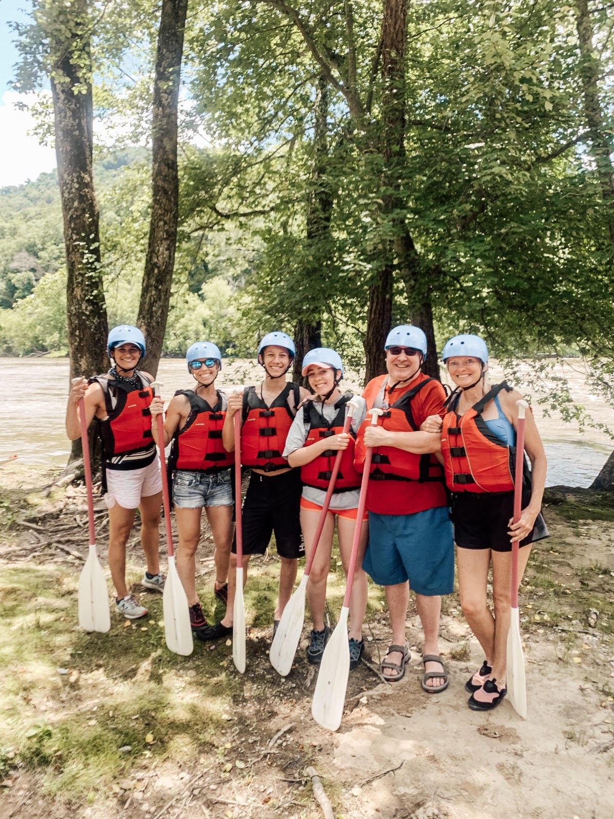 New volunteers Rae McMannis (far left) and Diane Sohl (far right) team up with IoH board member Tony Reid (second from right) to help make lasting memories with the Evans-Johnson family on the French Broad River!