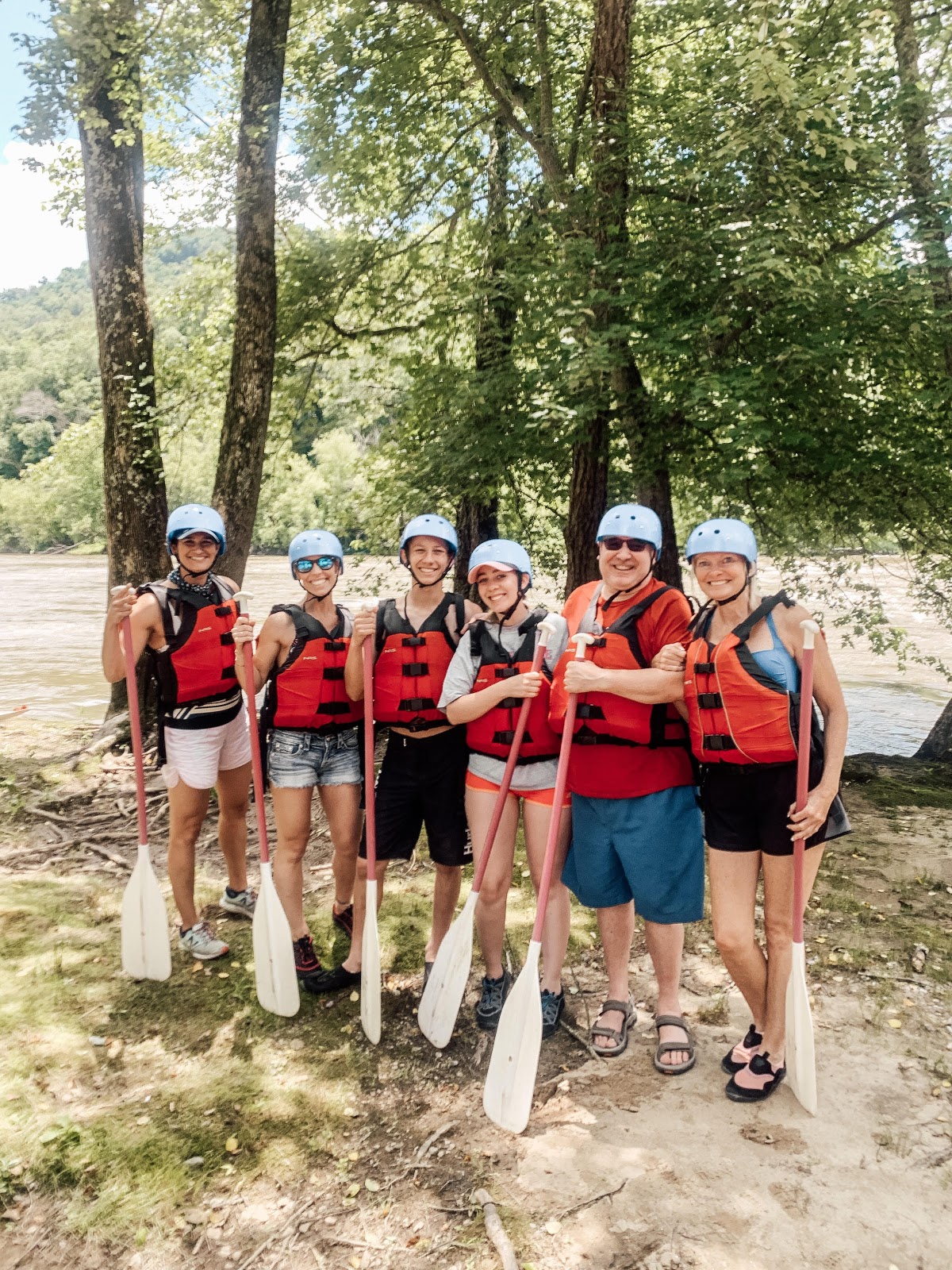 New volunteers Rae McMannis (far left) and Diane Sohl (far right) team up with IoH board member Tony Reid (second from right) to help make lasting memories with the Evans-Johnson family on the French Broad River! 