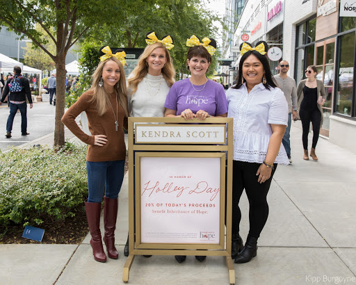 Teresa Bosch and her mouse ears blend in with Kendra Scott employees on Holley Day