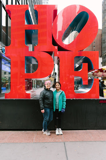 Woman and young girl standing in front of the HOPE monument in New York City