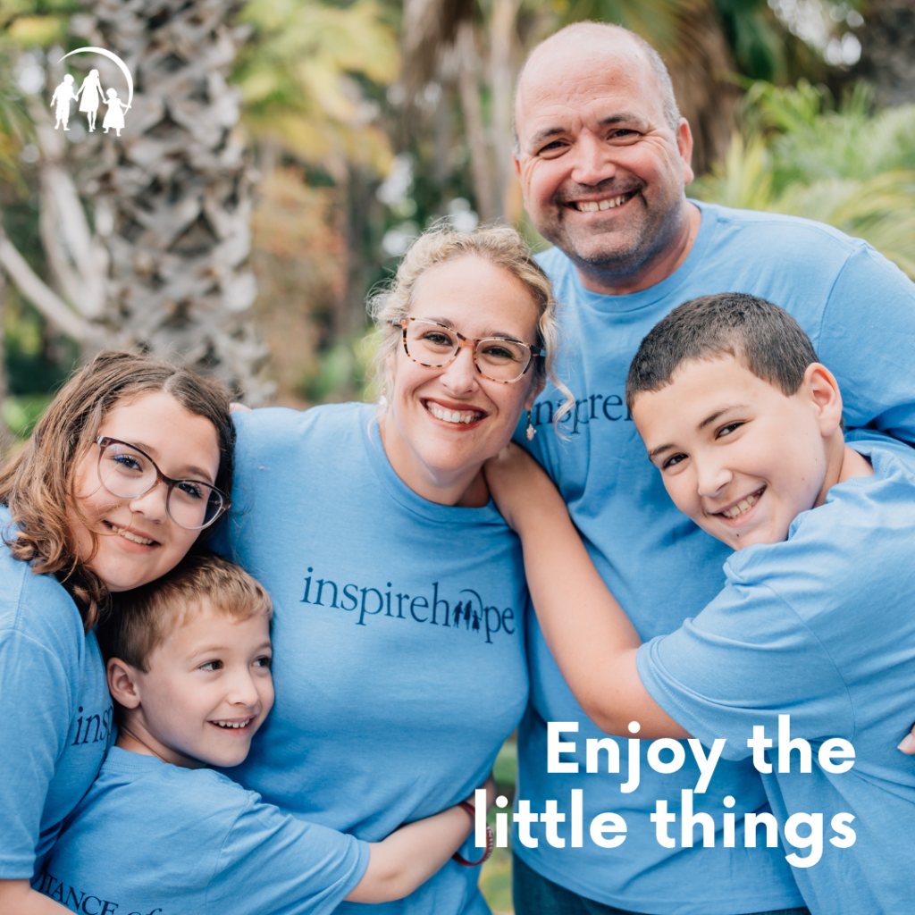 Family wearing blue Inheritance of Hope t-shirts smiling for a photo.