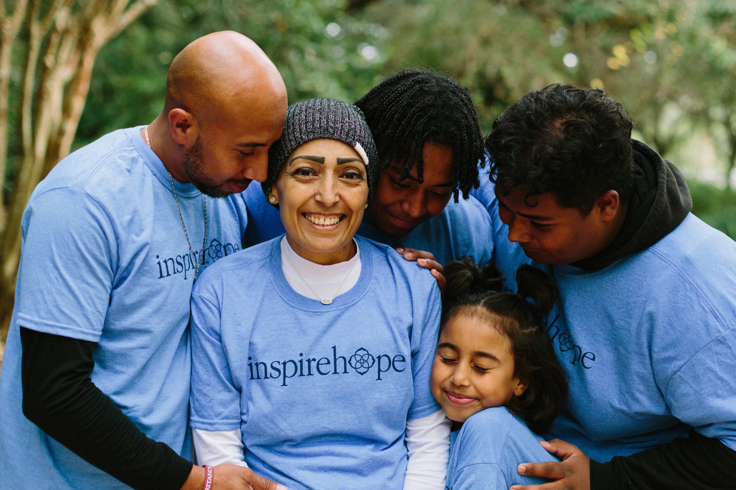 Family hugging mom with cancer