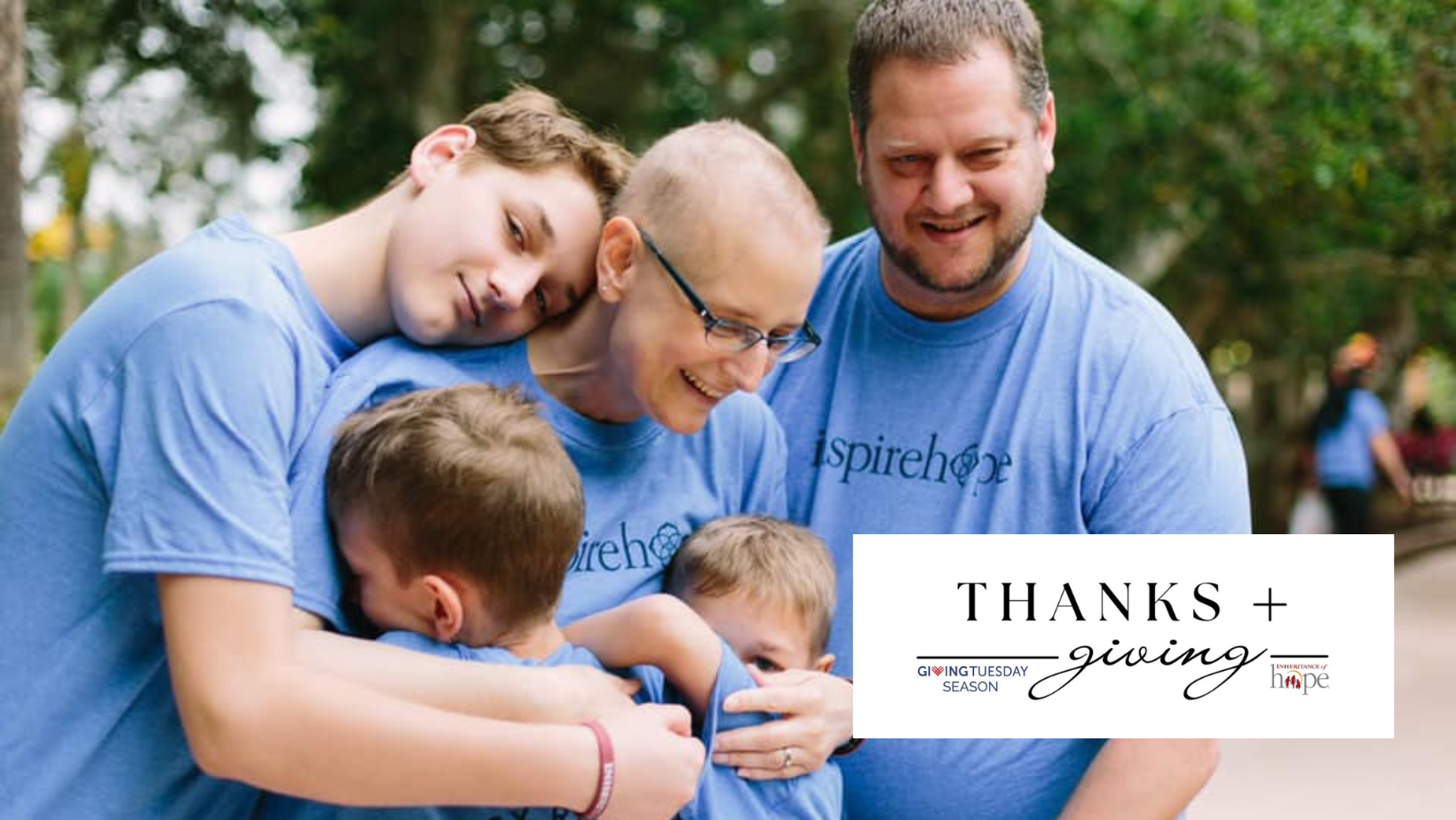A family hugging and smiling while wearing light blue Inheritance of Hope t-shirts