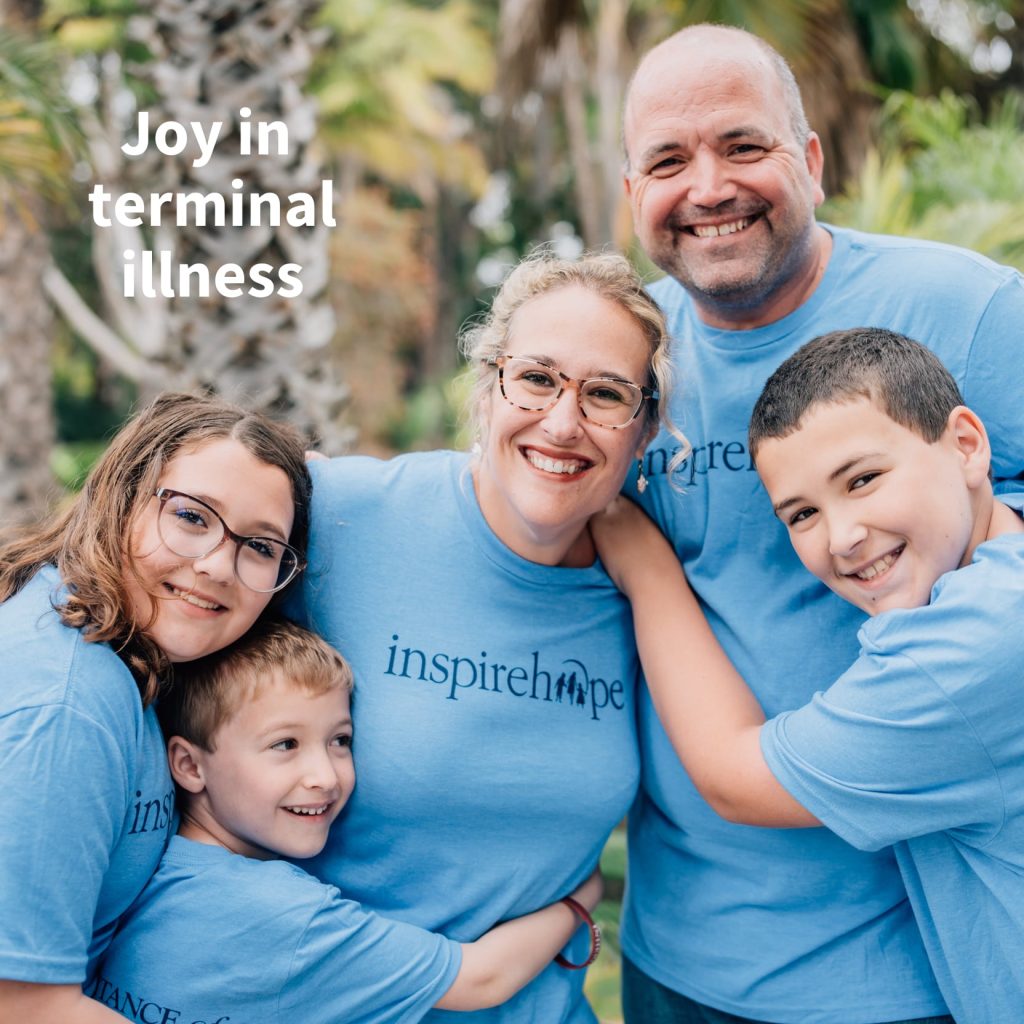 Family wearing blue Inheritance of Hope t-shirts smiling for a photo