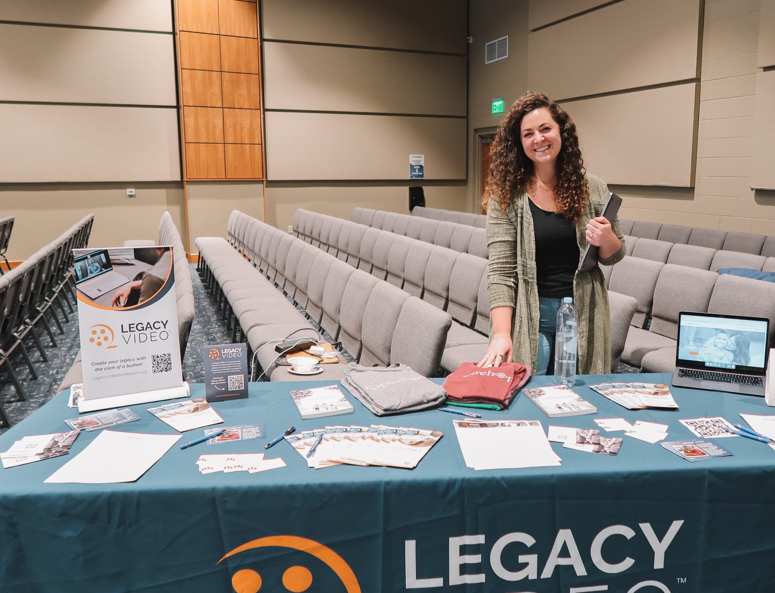 Inheritance of Hope staff member, Ellie Ledin, at a table with Legacy Video information.