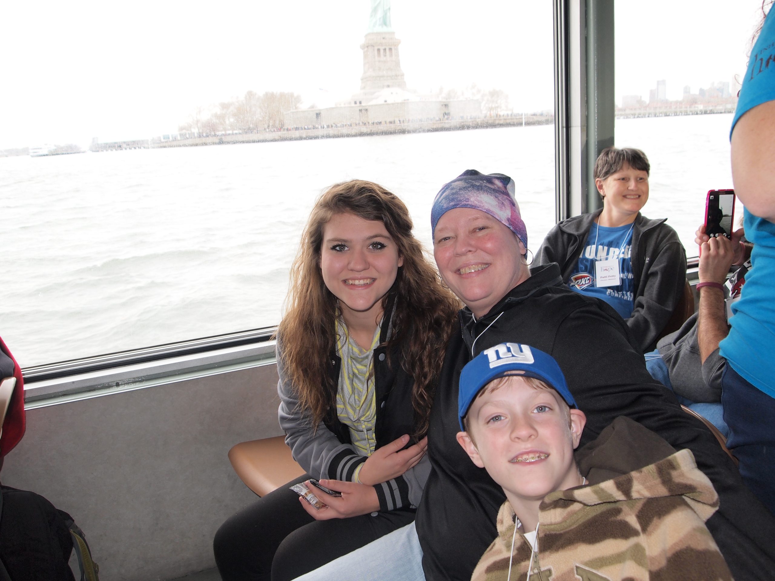 Photo of a mom with cancer and her young daughter and son on a New York City boat tour