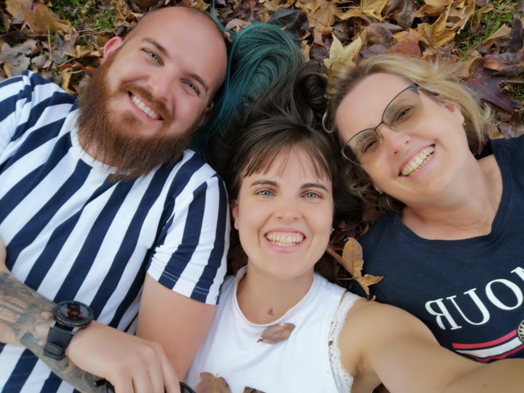 Photo of a family laying in a pile of leaves