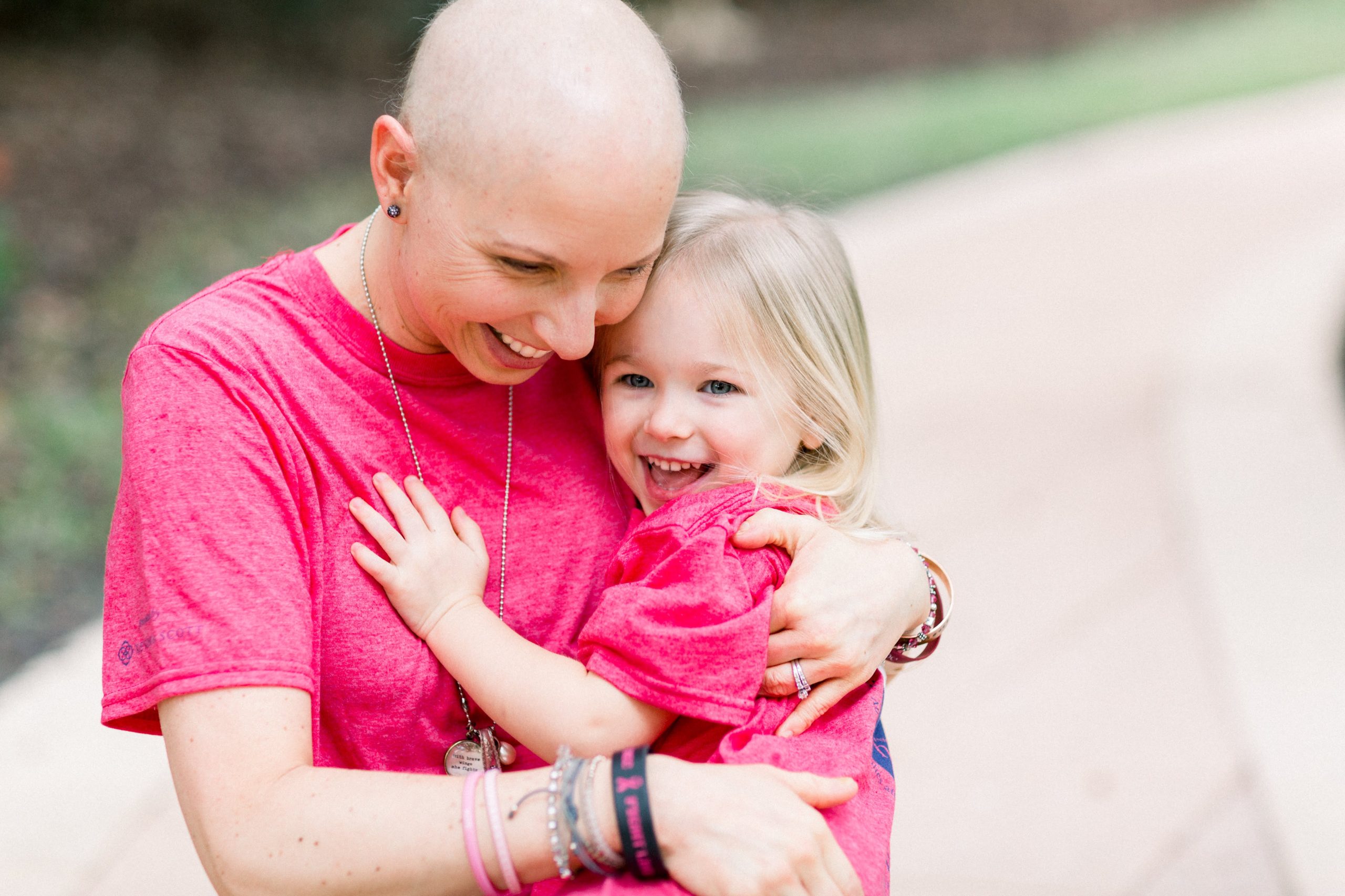 Photo of a mom with cancer hugging her daughter.