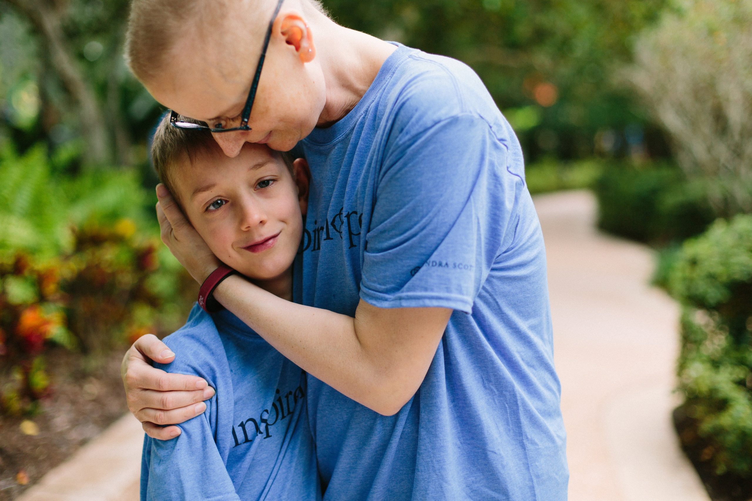 A mother with cancer embracing her young son