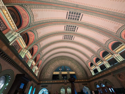 A large room with a detailed arch ceiling