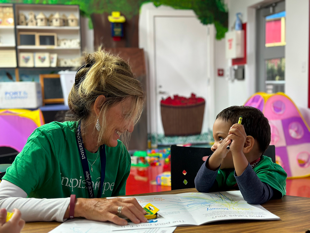 IMG_0384 Melissa Condrey 1 Melissa Condrey coloring at a table with a young boy in a playroom