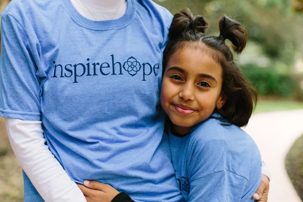 A young girl embracing her mother