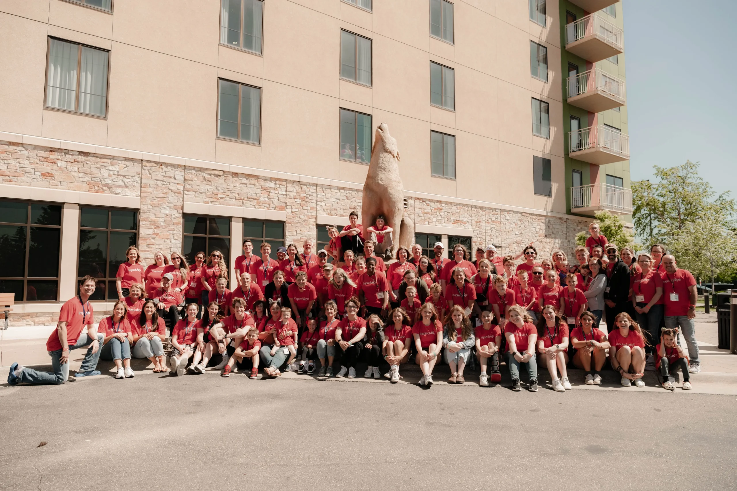minneapolis-68 Group photo of families and volunteers in red Inspire Hope shirts