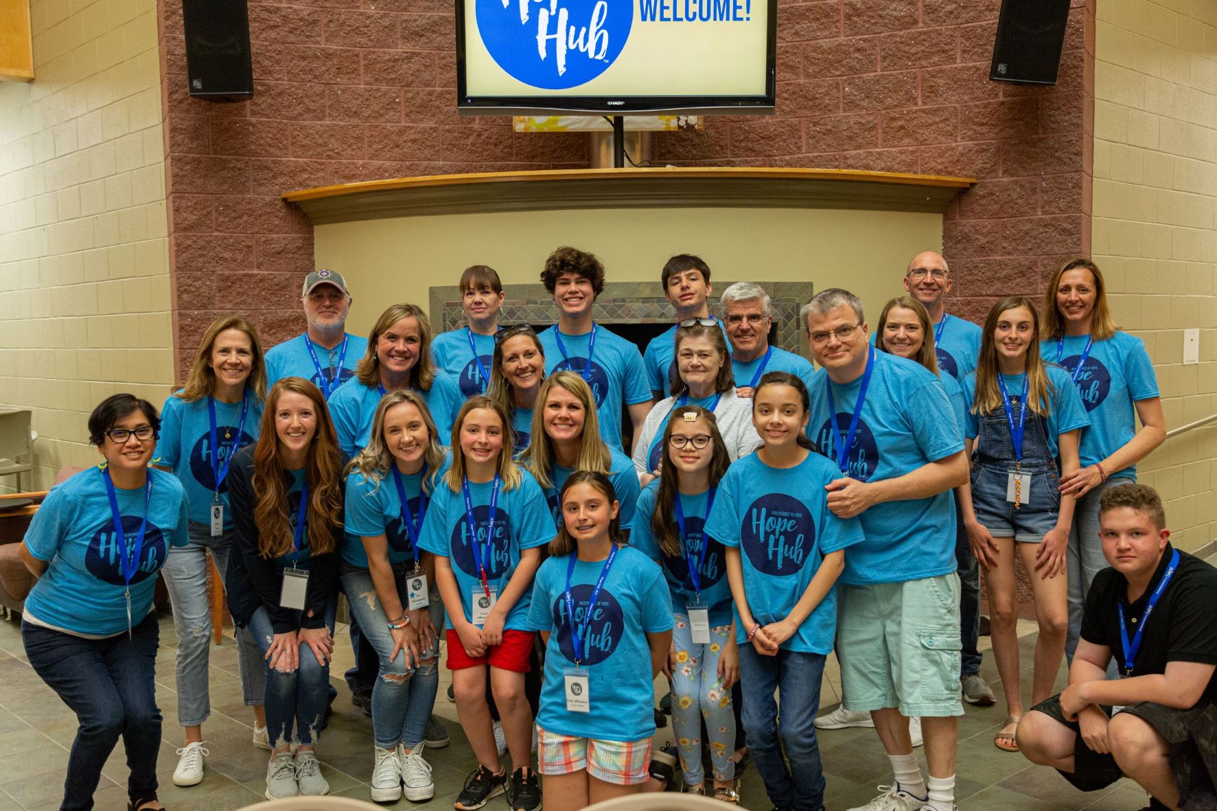 resized A group photo of people in blue Hope Hub shirts
