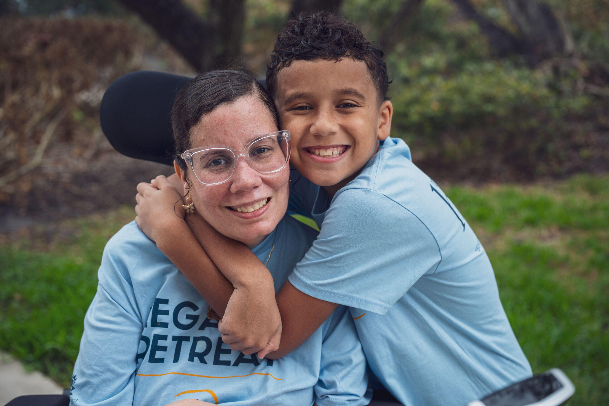 Woman with ALS being hugged by her child