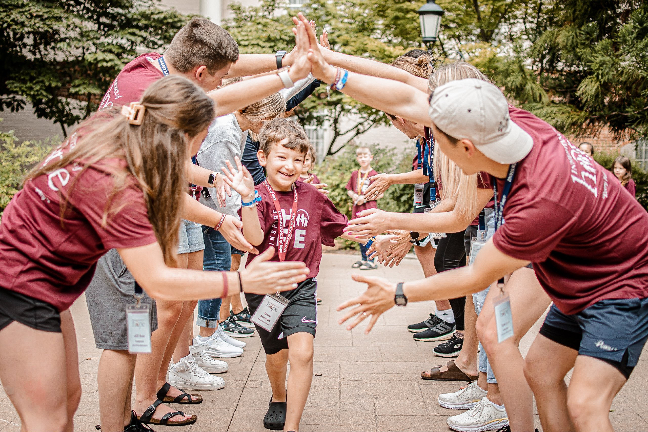 A child running through a cheering crowd